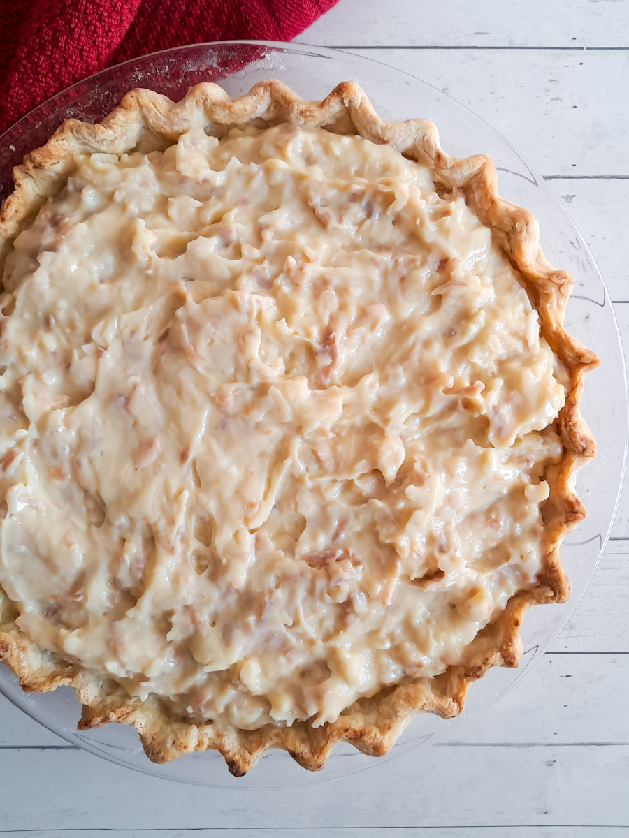 9" cream pie ready to be topped with whipped cream.