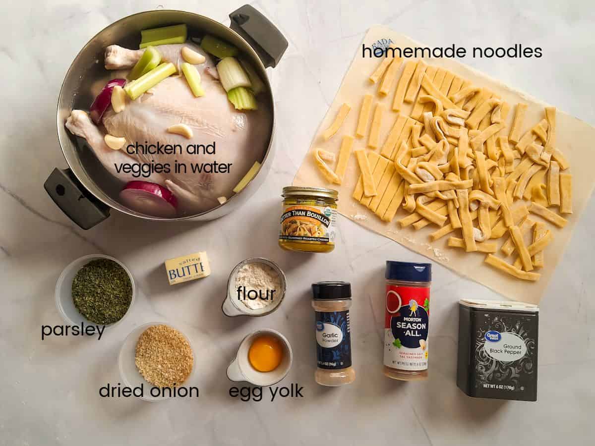 Ingredients: chicken in pot with veggies and water ready to cook, homemade noodles, flour, egg yolk, butter, and seasonings.