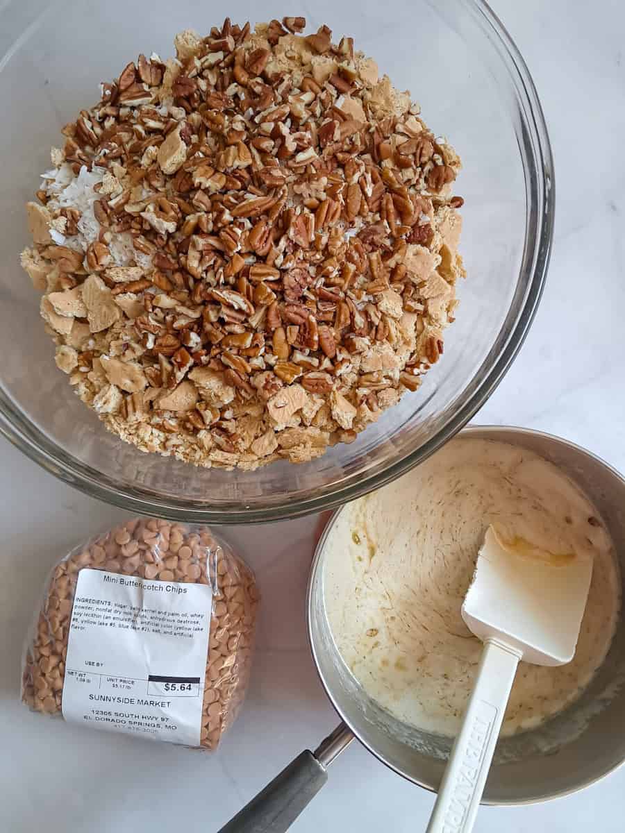 a large bowl with ingredients to make homemade granola, another pot with the melted butter and brown sugar mixture, and a bag of butterscotch chips.