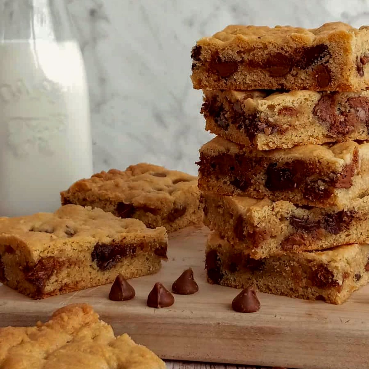 a stack of Amish chocolate chip cookie bars with milk.