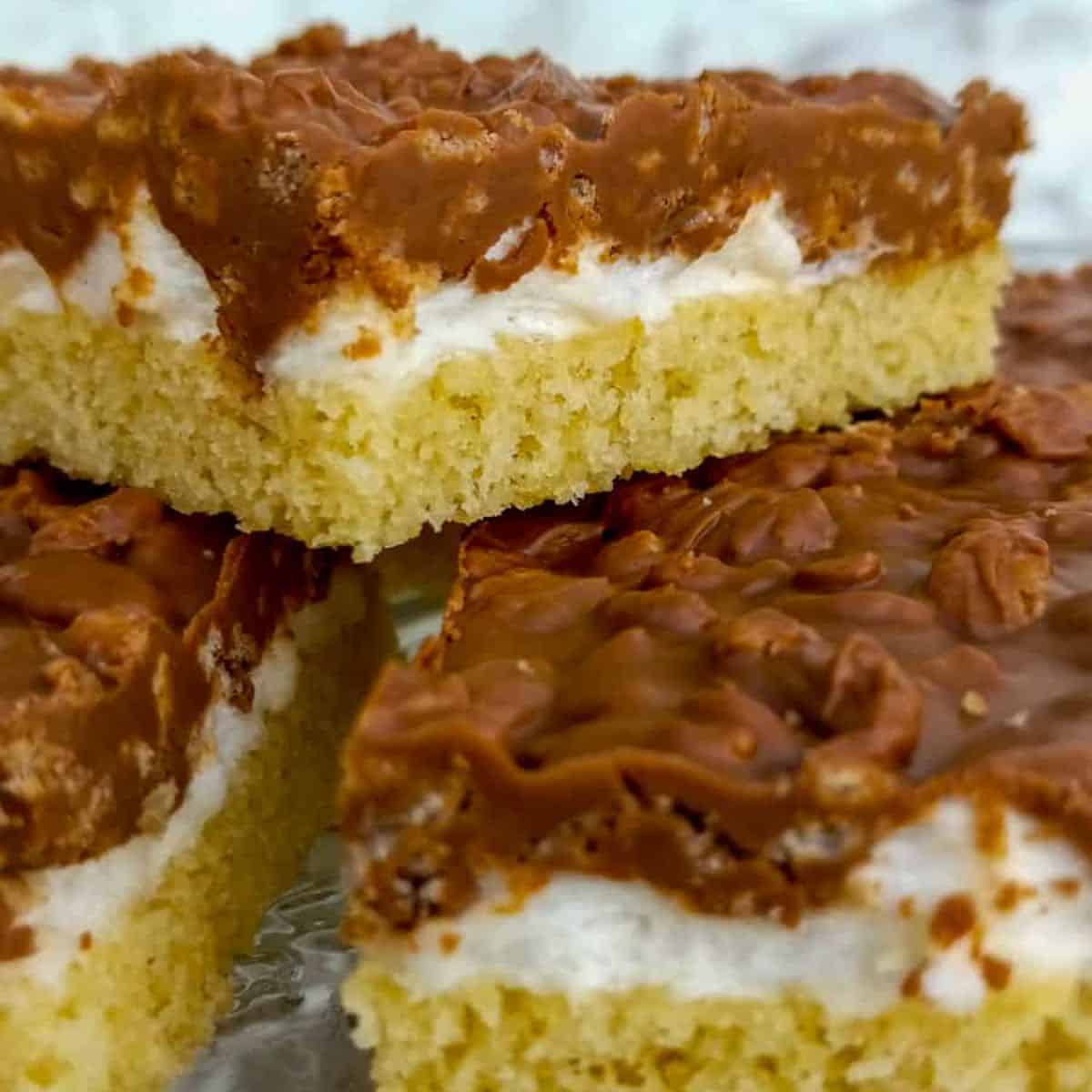 a stack of rice krspie chocolate peanut butter cookie bars.