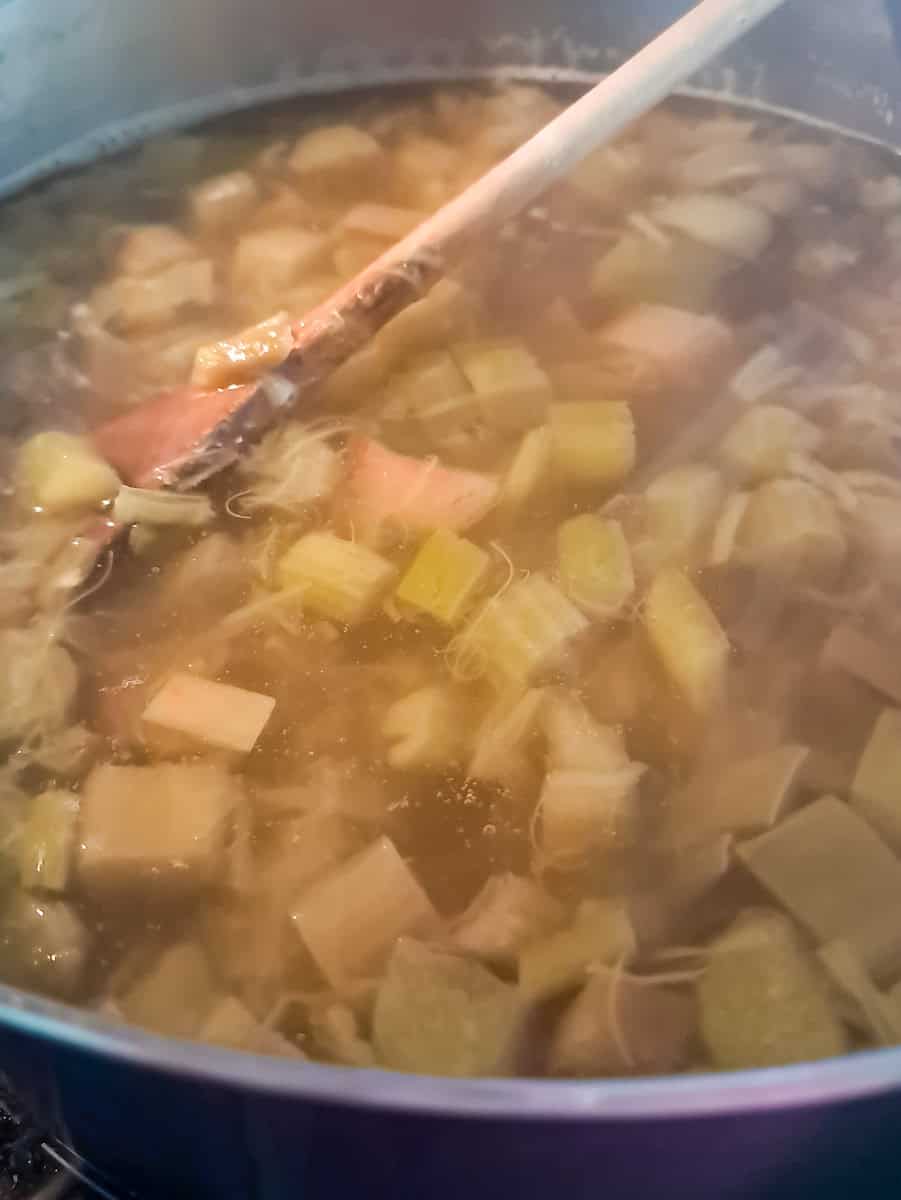cooked rhubarb with water in a large pot, ready to starin.