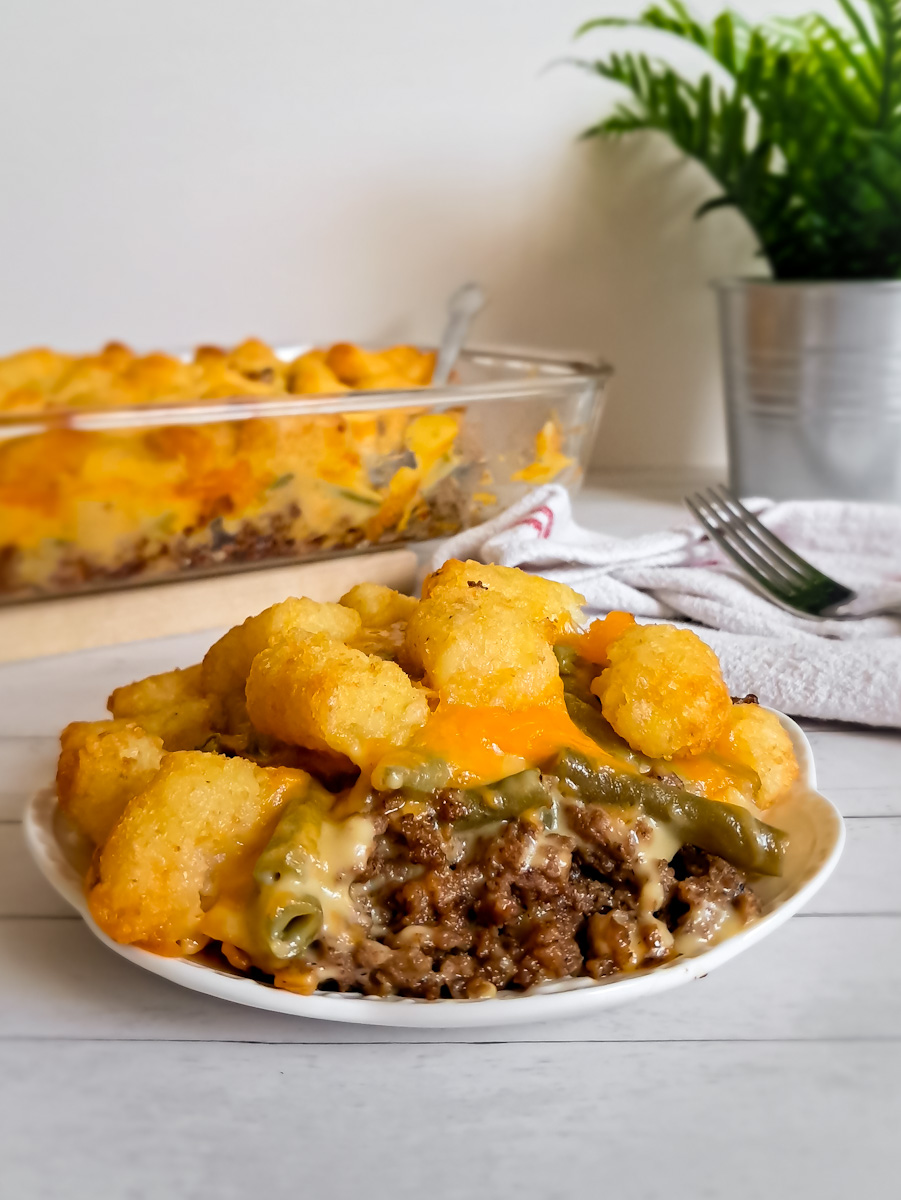 a plate full of easy Amish tater tot casserole featuring ground beef and tater tots.
