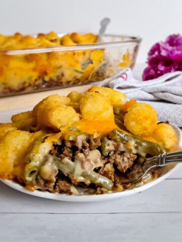 a plate full of Amish tater tot casserole with ground beef, green beans, and tater tots.