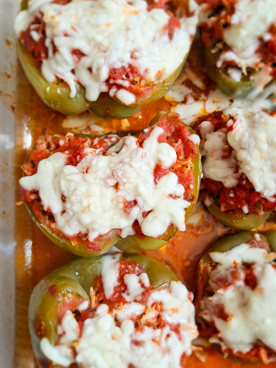 a 9x13" baking dish of Amish stuffed peppers with spaghetti sauce and cheese on top, ready to eat