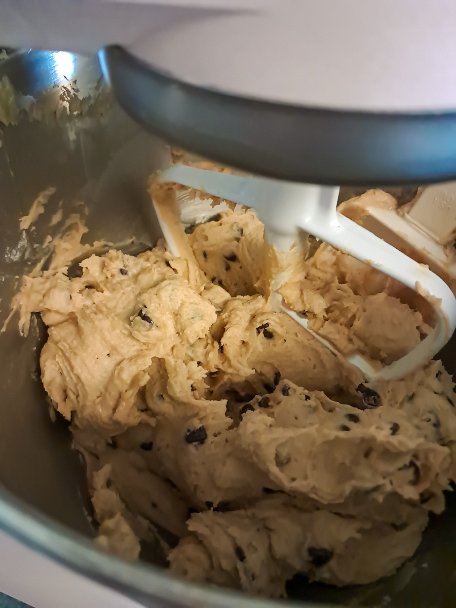mixed cookie dough with chocolate chips in a bowl, ready to bake.