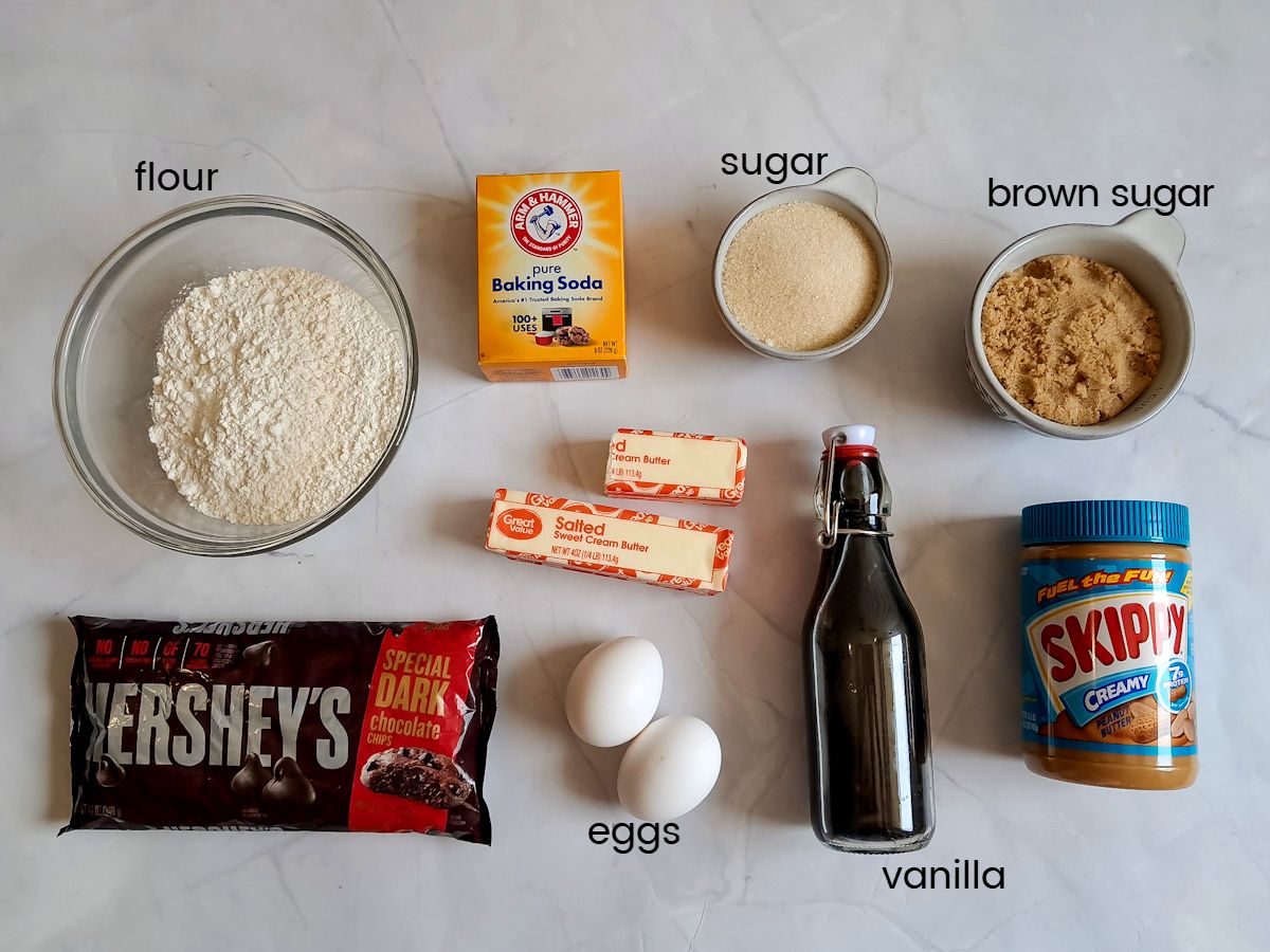 Ingredients: flour, sugar, brown sugar, peanut butter, butter, eggs, baking soda, vanilla, and chocolate chips.