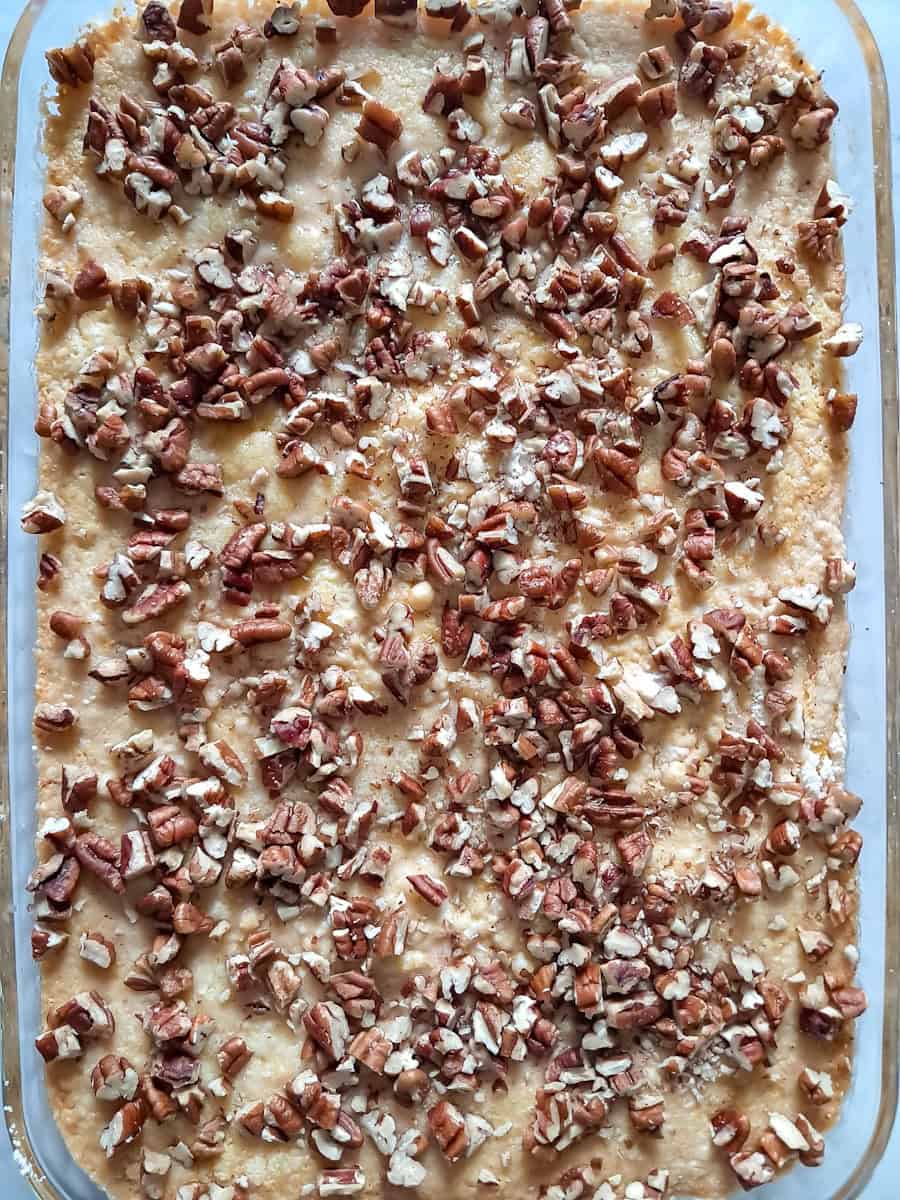 pecans sprinkled over top of the cake and now we will finish baking it.